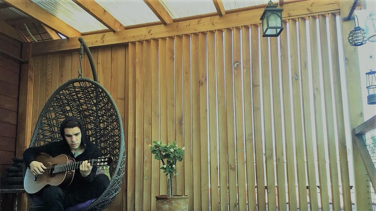 German Herlein playing classical guitar at home