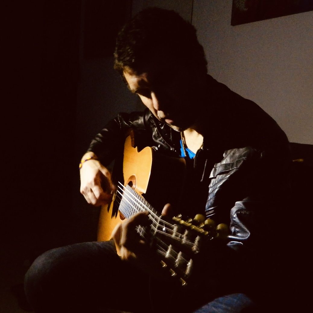 German Herlein playing guitar at home